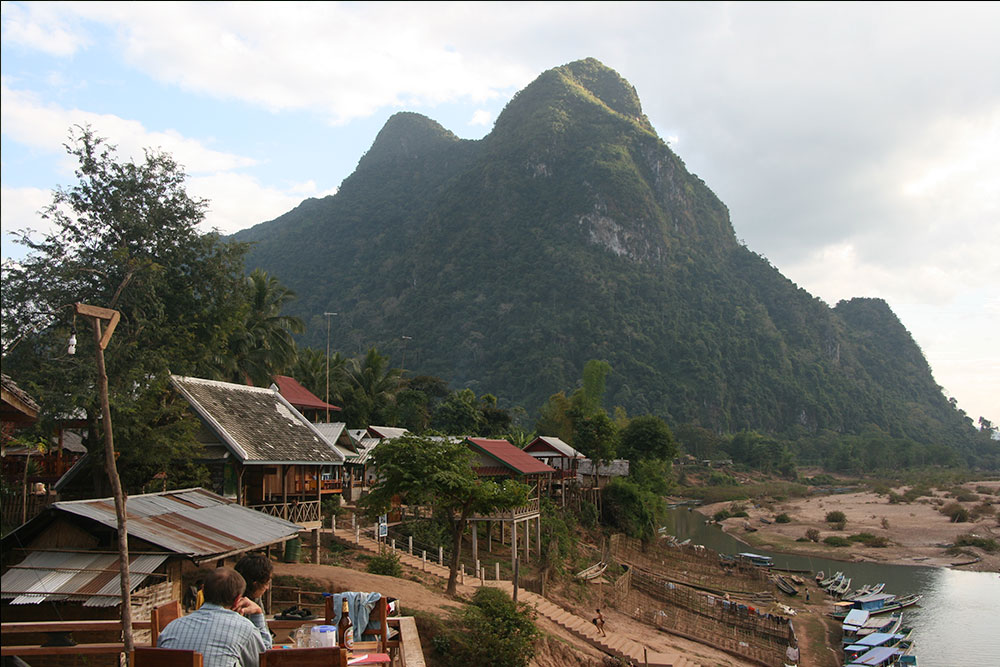 Sitting in a restaurant in Muang Ngoi, in front of the holly mountain named "young girl" for its languorous shape